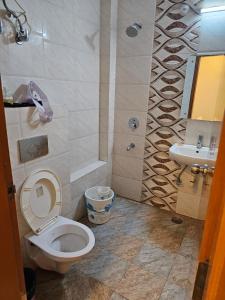 a bathroom with a toilet and a sink at HOTEL ORCHID in Lucknow