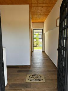 a hallway of a house with a door and a rug on the floor at Hotel Rural Irina in Badajoz