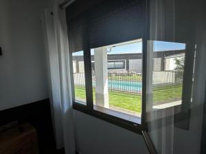 a window in a room with a view of a pool at Hotel Rural Irina in Badajoz