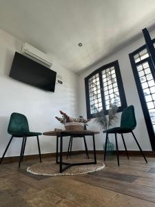 a living room with a table and two chairs at Hotel Rural Irina in Badajoz +10 photos
