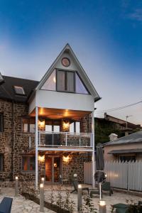 een bakstenen huis met kaarsen ervoor bij Dandy Villas Karpenisi Complex - Lux Chalets - Inflatable Pool-Hot Tub in Áyios Nikólaos