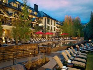 a group of lounge chairs sitting next to a swimming pool at Grand Hyatt Hotel And Condos in Vail