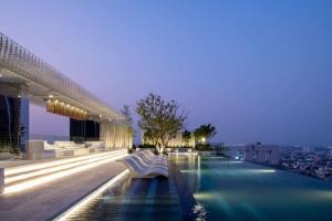 a pool on a building with a view of a city at 1 BR plus@42th FL /2-3 min walk to BTS MRT Ladprao in Bangkok