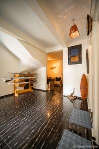 a living room with a wooden floor and a table at Easy Going in Imsouane