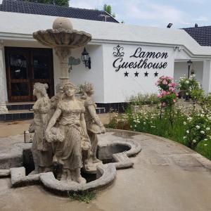 a statue of three women standing next to a fountain at Lamon Guesthouse in Kroonstad