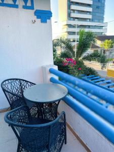 a table and two chairs sitting on a balcony at POUSADA AREIA DA PRAIA in Fortaleza