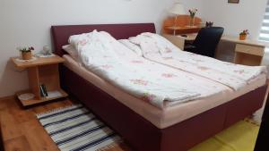 a bed in a room with at Berta Apartman in Senta