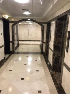 a hallway of a building with a tile floor at SN Realestate Resedent in Abu Dhabi