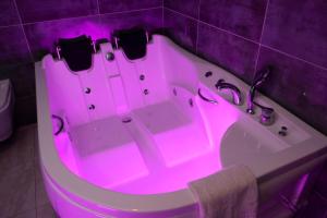 a bath tub with a pink light in a bathroom at THE NOVA HOTEL in Yalova +16 photos