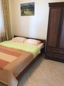 a small bedroom with a bed and a dresser at Apartment Nelli in Herceg-Novi