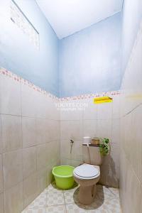 uma casa de banho com um WC e uma tigela verde em Destiny House em Yogyakarta