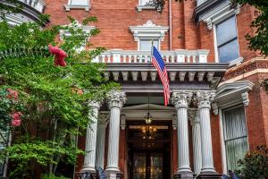 an american flag flying in front of a building at Kehoe House, Historic Inns of Savannah Collection in Savannah