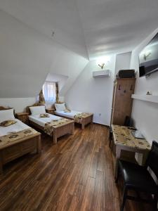 a large room with two beds and a couch at Pensiunea Nobil Medieval in Sighişoara +26 photos