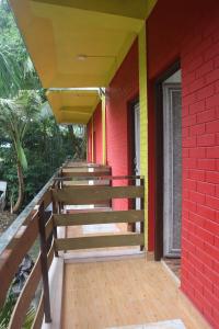 a row of wooden stairs on a red building at Kalapani Nest in Port Blair