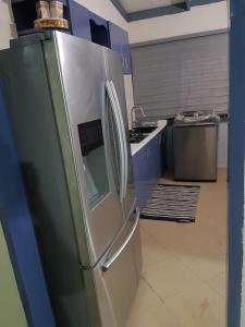 a kitchen with a stainless steel refrigerator at Apartments for short stay in Ashalebotwe