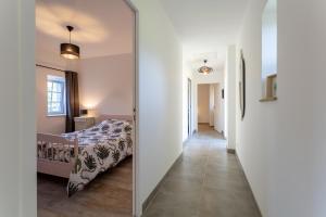 a bedroom with a mirror next to a bed at Gite plain-pied - 4 personnes in Landrévarzec