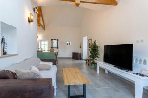 a living room with a large flat screen tv at Gite plain-pied - 4 personnes in Landrévarzec