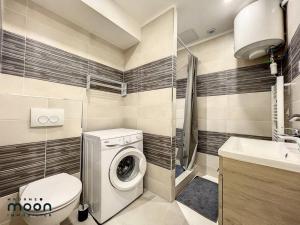 a bathroom with a washing machine and a sink at Studio rénové centre-ville de Lagnieu / WIFI in Lagnieu