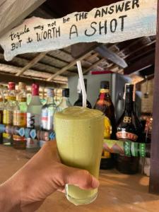 a hand holding a drink with a straw at KOKONUT HUT RETREAT & CAMPING SITE RENTAL in Romblon
