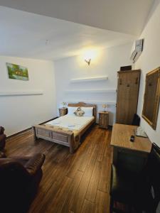 a room with a bed in the middle of a room at Pensiunea Nobil Medieval in Sighişoara