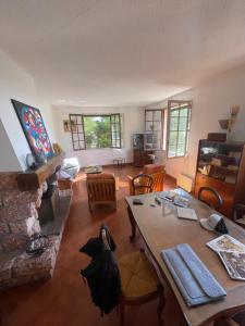 a living room with a table and a fireplace at Cote Bleue in Carry-le-Rouet