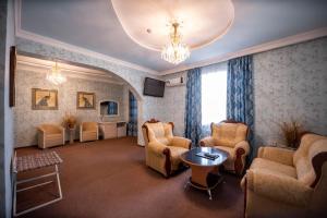 a large living room with chairs and a chandelier at Reikartz Modarixon Bukhara in Bukhara