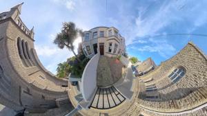 a reflection of a building with a palm tree at Prospect House - Elegant 4-Bed Family Escape Near Ward Park & Marina in Bangor