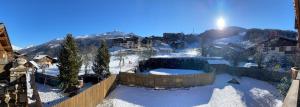 a view of a snow covered town with a mountain at Les Dolomites in La Plagne Tarentaise