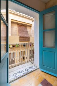 a door leading into a room with a balcony at Traditional Maltese Townhouse - Close to Sea in Senglea