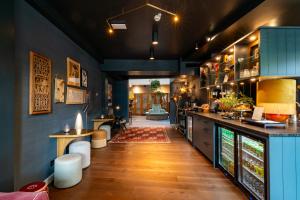 a kitchen with a counter and a bar in a room at Hotel Mai Amsterdam in Amsterdam