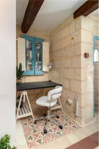 a home office with a desk and a chair at Traditional Maltese Townhouse - Close to Sea in Senglea