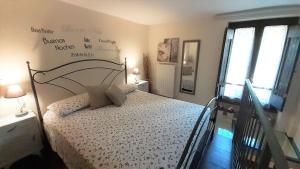 a bedroom with a bed with a white comforter at Bilocale in strada Vestricciano Genna con giardino privato in Perugia