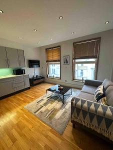 a living room with a couch and a table at 1 BR in St James Piccadilly HY10 in London