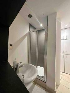 a white bathroom with a sink and a shower at 1 BR in St James Piccadilly HY10 in London