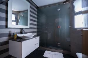 a bathroom with a glass shower and a sink at Casablanca Marina by Saloua in Casablanca +139 photos