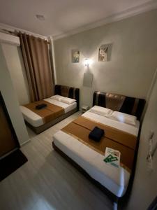 a hotel room with two beds in a room at Perhentian Suria in Perhentian Island