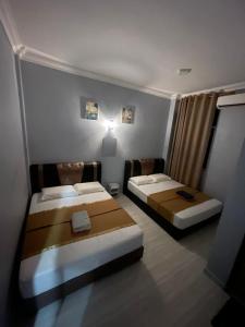 a room with two beds in a room at Perhentian Suria in Perhentian Islands