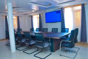 a conference room with a long table and chairs at DHE Jomels Hotel in Busia