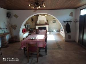 a dining room with a table and a fireplace at casale fucino monolocale in Avezzano