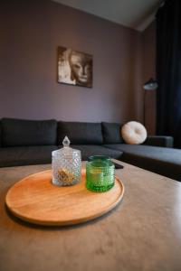 a wooden tray with two candles on top of a table at Olga Apartments in Grundarfjordur