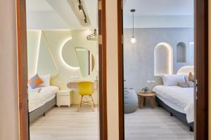 a room with two beds and a yellow chair at 墾丁包棟民宿覓謐villa in Hengchun
