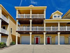 a large apartment building with red doors at Sandy Starfish in Port Aransas