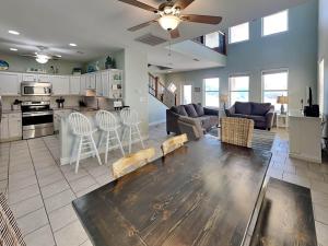 a kitchen and living room with a table and chairs at Sandy Starfish in Port Aransas