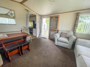 a living room with a desk and a chair at 6 Berth, Wheelchair Adapted Caravan At Southview Holiday Park Ref 33084s in Skegness