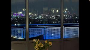 a room with a view of a city at night at The OMG penthouse in London