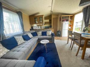 a living room with a couch and a table at Lovely Dog Friendly Caravan At Southview Holiday Park In Skegness Ref 33053s in Skegness