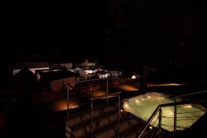a night view of a swimming pool in a yard at Finy Homes Stegersbach - Wellness Hideaways für Paare mit Sauna & Whirlpool in Stegersbach