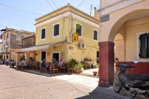 a scooter parked on the side of a street at Casa Mia Apartment in Corfu