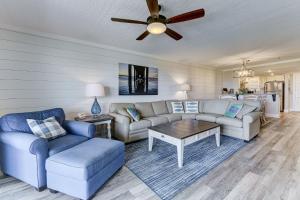 a living room with two couches and a ceiling fan at Island South 7 in St. Augustine