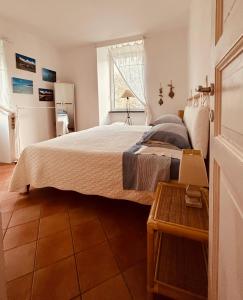 a bedroom with a large bed and a table at CHARMING APARTMENT VILLA WITH POOL 010-46-cav-0009 in Rapallo